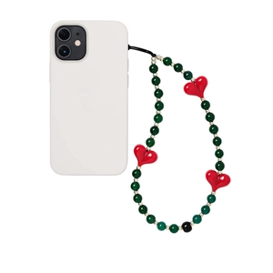 Handmade green beaded phone strap with red heart charms for women on white background