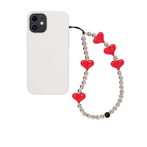 Detail shot of a white phone case with handmade beaded lanyard featuring red heart charms