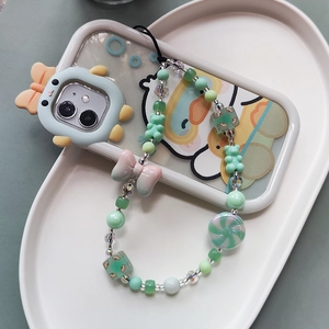 Colorful beaded phone strap with mint green beads, cute bear and candy charms in a tray