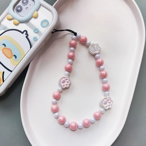 Pink and white beaded phone wrist strap with cute resin cat paw charms and beads