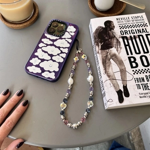 Detail of beaded phone wristlet with crystals and pearls on purple cloud phone case