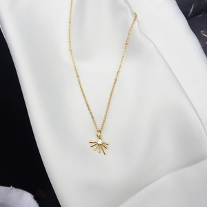 18K gold plated sunburst pendant necklace with zircon stone on elegant white silk background