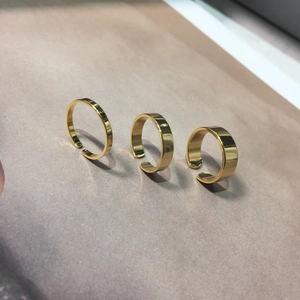 Three-piece gold minimalist rings set with varying widths and adjustable open design