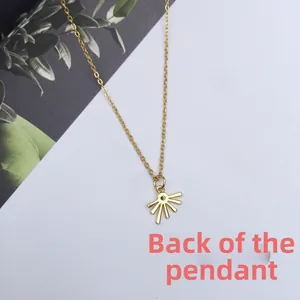 Back side detail of 18K gold plated sun pendant necklace on elegant background