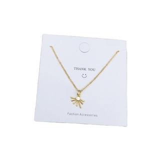 18K gold plated sunburst pendant necklace with zircon stone on white gift card display