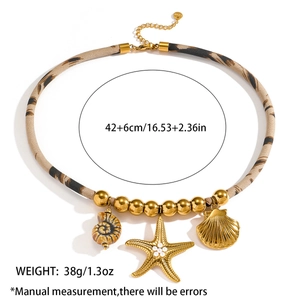 Detail view of ocean-themed necklace with gold starfish, seashell, and rope chain