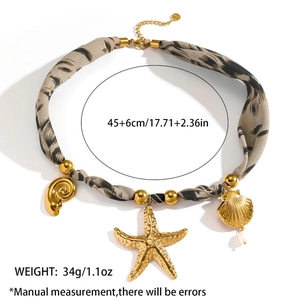 Detail of nautical necklace with sea shell starfish charms and leopard print fabric cord