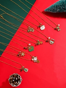 Detailed view of Christmas pendants featuring reindeer and snowflakes on gold bead chains