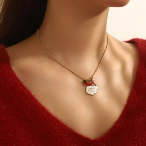 Detail of Christmas Santa Claus pendant necklace with colorful enamel on a gold chain