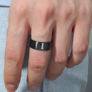 Detalle de anillo de acero inoxidable negro de 8mm con acabado cepillado y la letra I