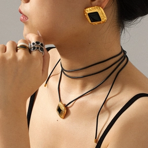 Vintage gold rhombus pendant necklace and matching earrings set with black resin detail