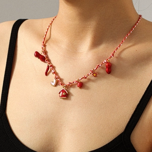Folk style woven cord necklace with red house, heart, and peanut pendants for women