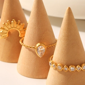 Three-piece gold plated stainless steel ring set with sunburst and zircon accents