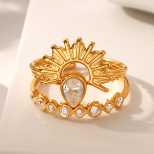 Luxurious gold-plated sunburst and wave ring set with sparkling cubic zirconia stones