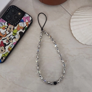 Beaded phone strap with silver bone charms and iridescent crystals on marble background