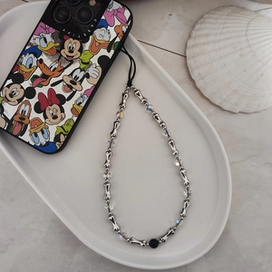 Detail view of woven beaded phone strap with silver bone charms and iridescent crystals