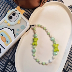Detail of colorful beaded phone strap featuring green resin bears and mixed pastel beads