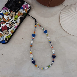Colorful beaded phone charm strap with heart-shaped beads on a marble tabletop
