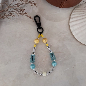 Close-up of beaded keychain with blue bear pendants and colorful acrylic beads