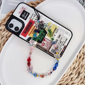 Colorful rainbow beaded butterfly phone charm strap with acrylic beads on a tray
