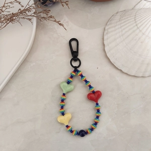Detail of colorful striped beads and acrylic hearts on a heart-shaped beaded keychain