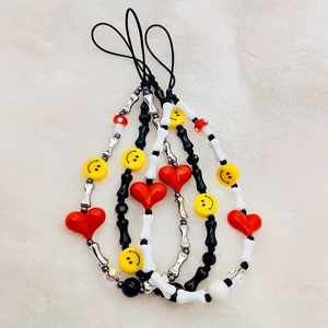 Handmade beaded phone charms with red heart, yellow smiley face and bone beads on faux fur