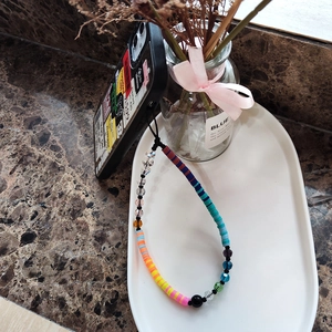 Colorful handmade polymer clay and glass bead phone wrist strap with vibrant gradient segments