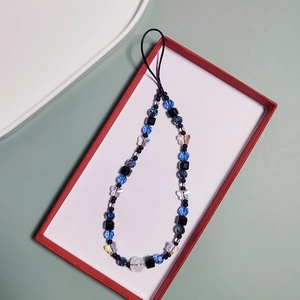 Beaded phone charm strap with blue and black beads and iridescent crystal butterfly