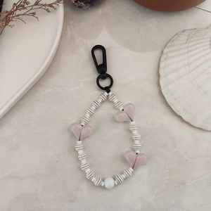 Detail of beaded heart keychain with pink acrylic hearts and black spring clasp hook