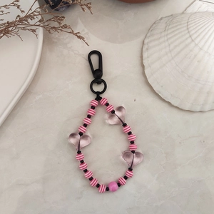 Detail of beaded keychain featuring pink striped beads and translucent acrylic hearts