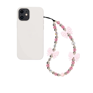 Pink bow beaded phone charm strap with metallic silver accents on a white phone case