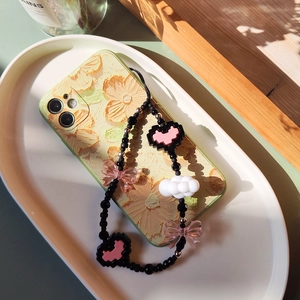 Acrylic beaded phone charm with pink heart and butterfly on floral embossed phone case