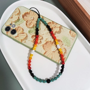 Handmade colorful glass beaded phone strap with gradient beads on a floral phone case