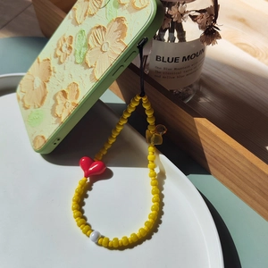 Cute yellow duck and red heart beaded phone strap on floral green mobile case