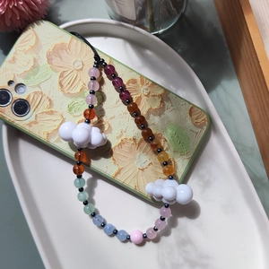 Colorful acrylic cloud beaded phone strap with gradient beads on a floral phone case