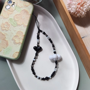 Handmade beaded phone charm with black heart and white cloud beads on floral case