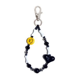 Handmade beaded keychain with a black heart pendant and yellow smiley face charm