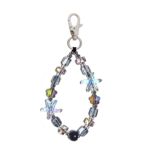 Detail of beaded keychain with iridescent starfish and flower charms on lobster clasp