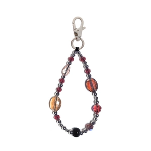 Close-up of beaded keychain with burgundy faceted beads and silver metal lobster clasp