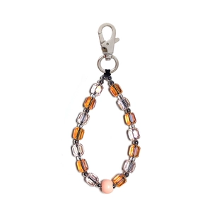 Detailed macro view of faceted crystal beads with a pink frosted bead on a silver lobster clasp