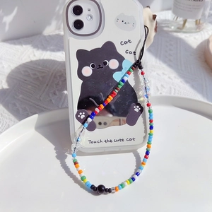 Colorful beaded phone strap with cartoon cat case on a minimalist white texture background