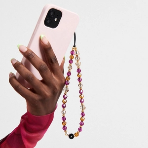 Bijou de téléphone en perles de cristal violet et ambre sur coque rose mat