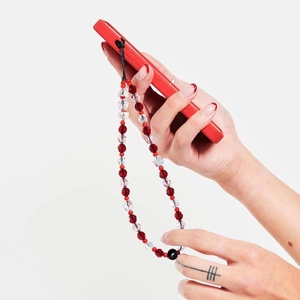 Dragonne de téléphone perlée à la main avec perles de cristal rouges et facettées