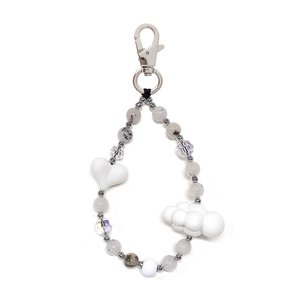 Close-up of handmade beaded keychain with marble beads and white heart pendants
