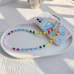 Detailed macro view of colorful beaded mobile phone lanyard with candy colored resin beads