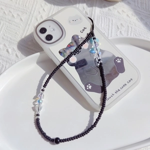 Detail of handmade black beaded phone strap with iridescent beads and a cat motif case