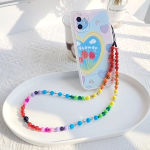 Detailed shot of multi-color beaded crossbody strap for phone and camera with heart pattern