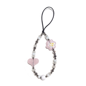 Detail of pink crystal heart and flower beads on a handmade beaded phone charm strap