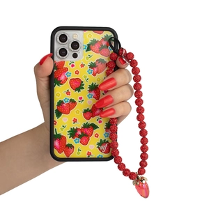 Detail of strawberry flower phone case with red rhinestone beaded wrist strap and charm