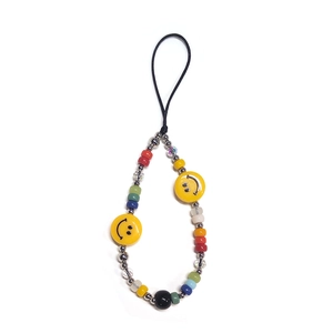 Detail of colorful beaded phone strap featuring yellow smile faces and mixed crystals